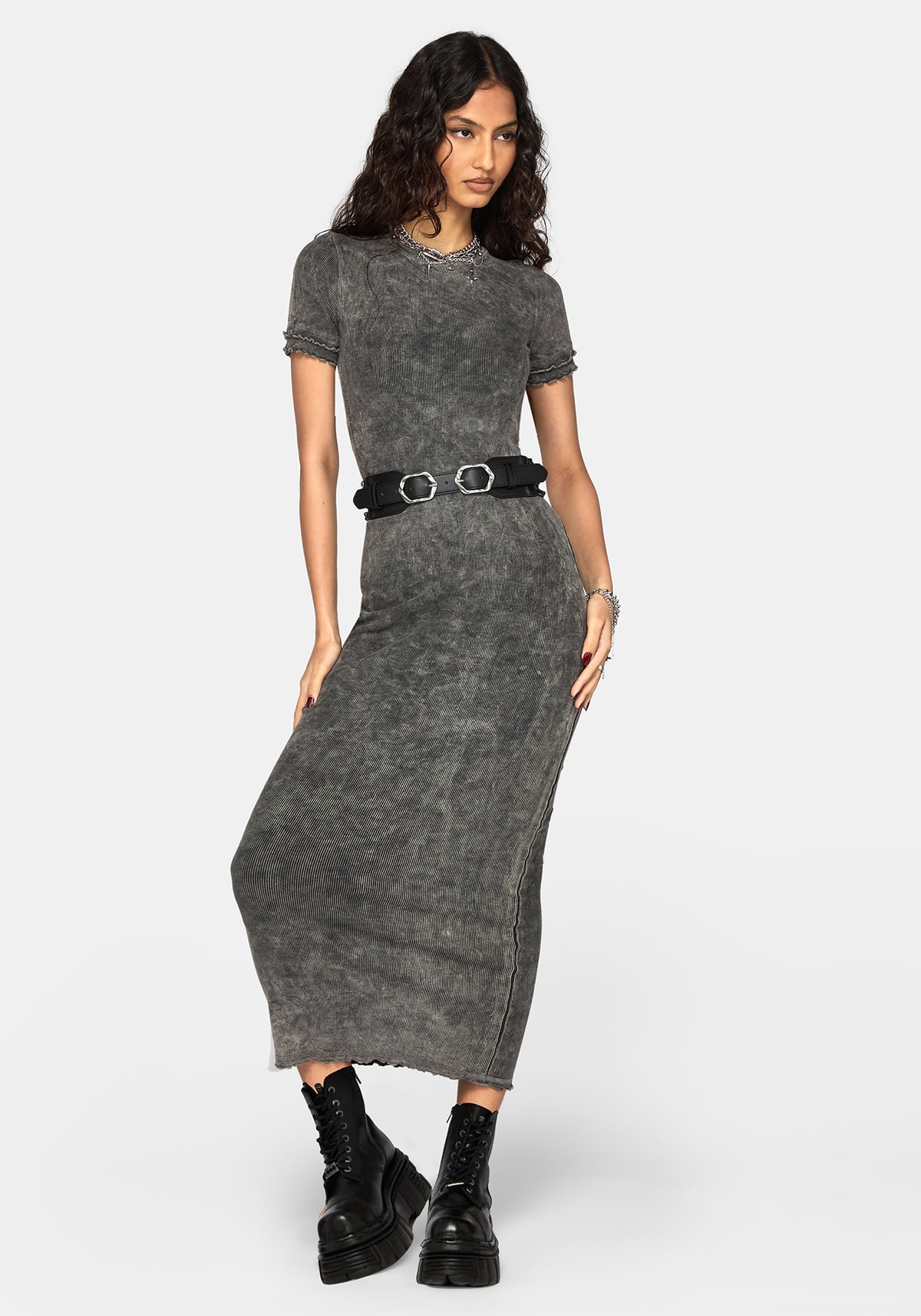 A woman modeling a short-sleeve, crew-neck, acid-wash gray maxi dress with a black belt featuring silver buckle details, paired with black platform combat boots, against a light gray studio background.