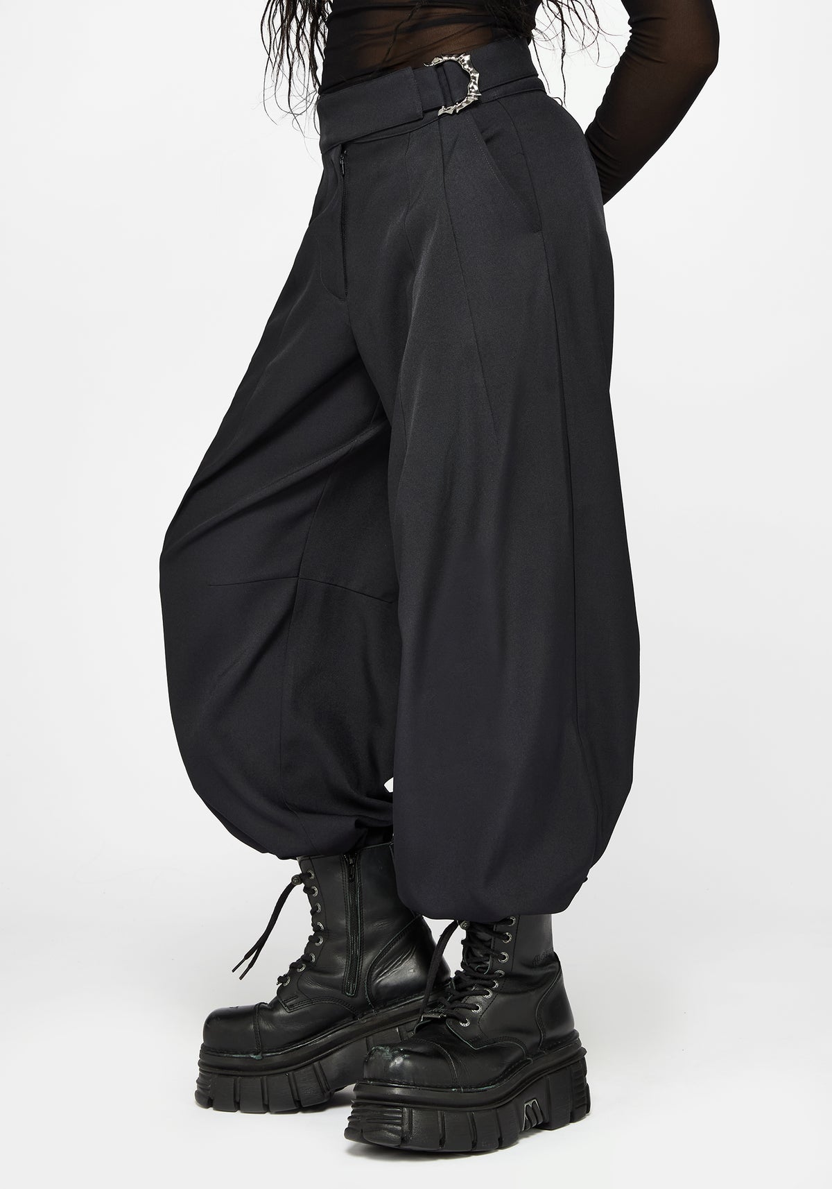 Black balloon style pants with a silver buckle belt, worn by a model with black platform combat boots against a light gray background.
